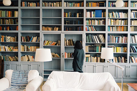 woman wearing black top looking for books thumbnail