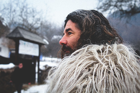 shallow focus photography of person wearing white fur coat outdoors thumbnail