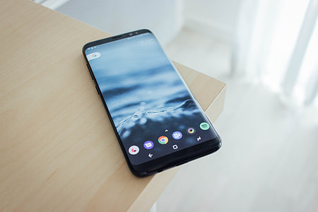 black Android smartphone on beige top table thumbnail