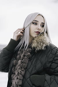 woman in black bubble jacket with white hair posing for photo thumbnail