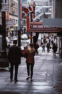 Man and Woman Walk Beside Store thumbnail