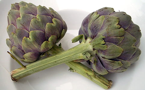 two green vegetables on top of white container thumbnail