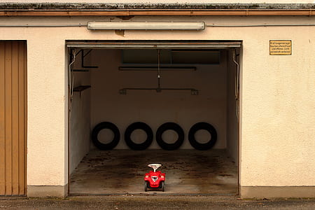 empty ride-on toy car in garage thumbnail