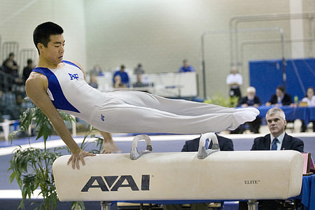 man doing gymnastics on pommel horse thumbnail