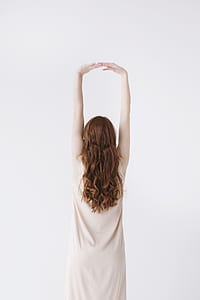Woman in Beige Dress Stretching Her Hands thumbnail