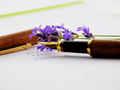 purple cluster flower beside brown fountain pen thumbnail