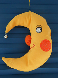 yellow crescent moon plush toy in close-up photo thumbnail