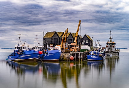 blue boat on body of water thumbnail