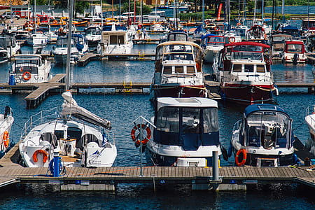White Blue Sailboats Dock on Water during Daytime thumbnail