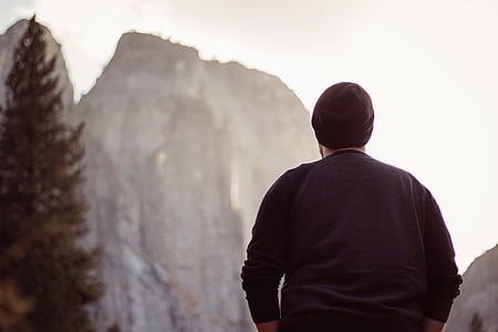 man in black sweater facing mountain thumbnail