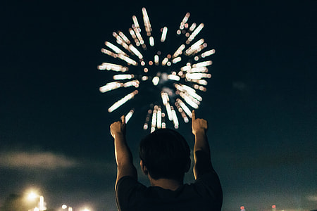 man in black top watching fireworks thumbnail