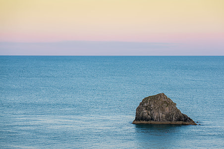 rock formation on body of water thumbnail