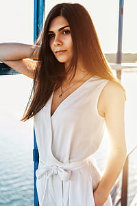 woman standing near glass window during daytime photo thumbnail