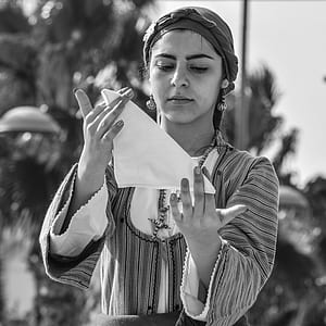 grayscale photography of woman holding handkerchief thumbnail