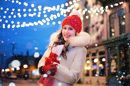 woman in white coat standing and smiling thumbnail