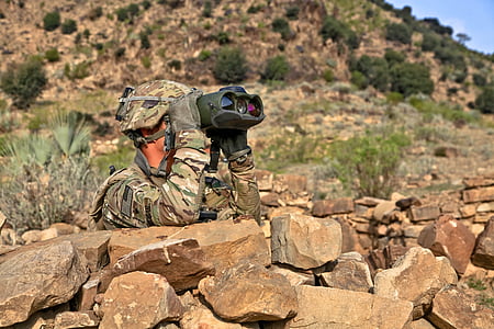 soldier behind rock using binocular thumbnail