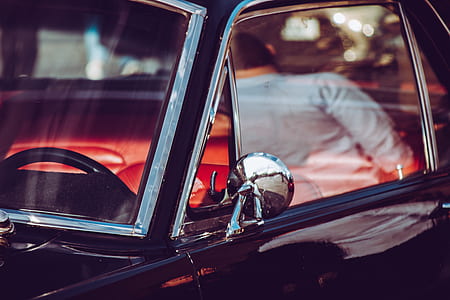 man standing near black car thumbnail