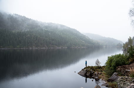 person standing near river bank thumbnail