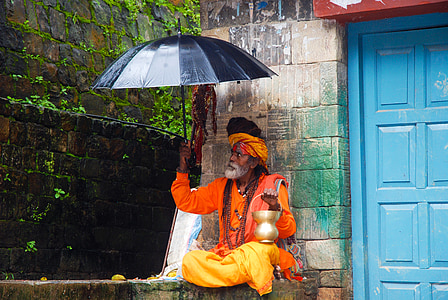 man holding black umbrella thumbnail