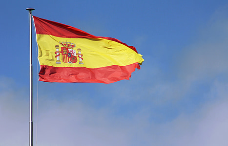 red and yellow striped flag under blue sky at daytime thumbnail