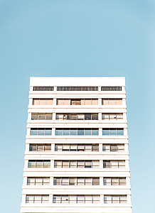 white concrete building with glass panels thumbnail