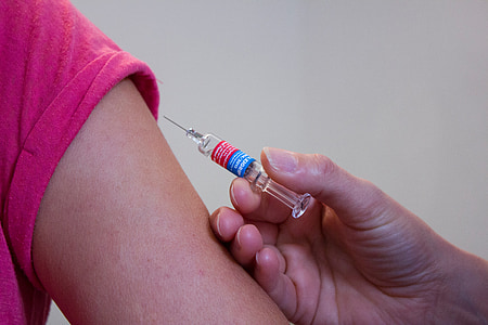person holding syringe on person's arm thumbnail