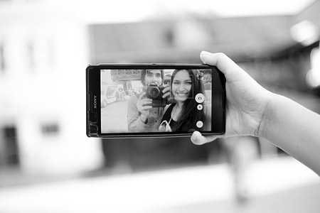 person holding Sony android smartphone taking picture thumbnail