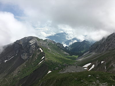 green and brown mountains under gray sky during daytime thumbnail