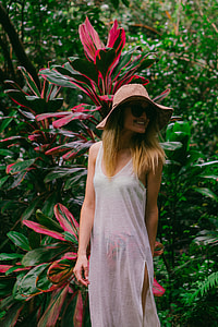 woman wearing white dress standing near plant thumbnail