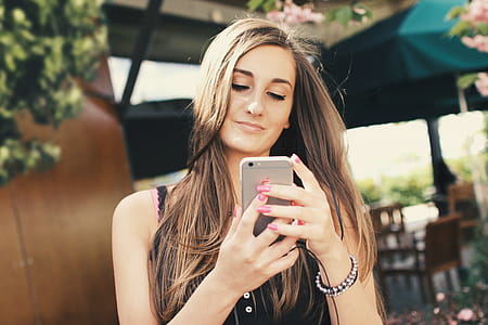 A young girl uses an app for a chat on a smartphone outdoors thumbnail