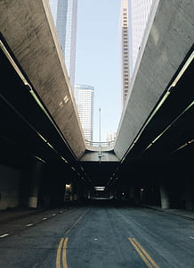 architectural photo of concrete bridge near high-rise building thumbnail