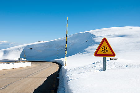 gray asphalt road in between snow field thumbnail