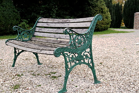 brown and green bench near plants thumbnail
