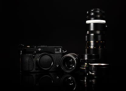 black DSLR camera beside lens thumbnail