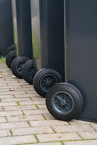 gray vehicle wheel and tires on gray pavement thumbnail
