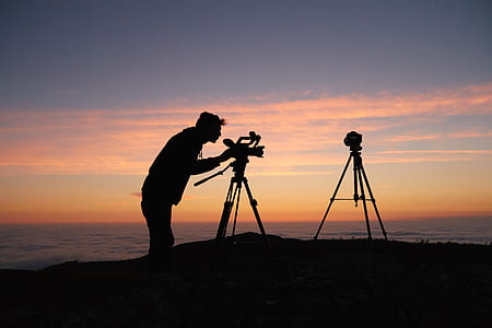 silhouette of man using camera during golden hour thumbnail