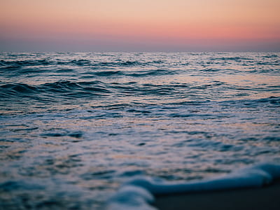 ocean under red and gray sky thumbnail