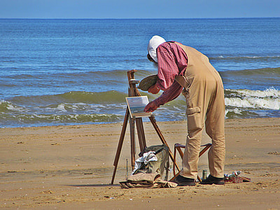 person painting near body of water thumbnail