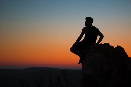 man sitting on edge of stone thumbnail