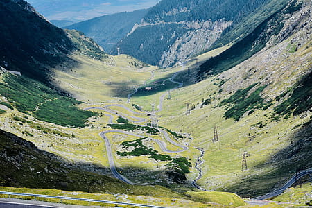 Aerial View Photography of Asphalt Road in Between Mountain thumbnail