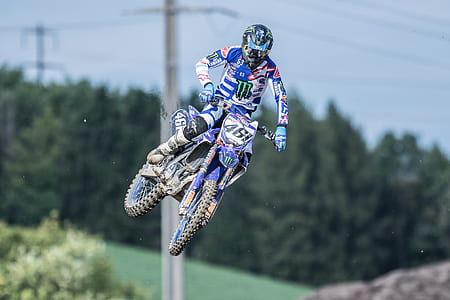 person riding dirt bike over obstacles thumbnail