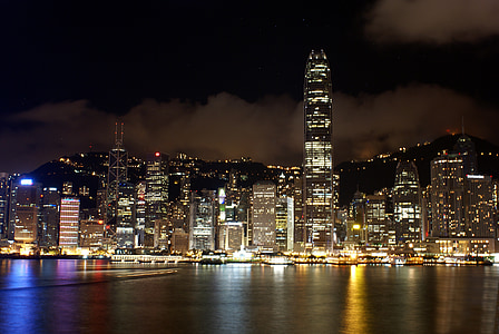landscape of high rise buildings under black sky thumbnail