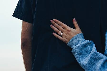 woman holding man back during daytime thumbnail