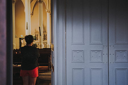 woman standing inside church thumbnail