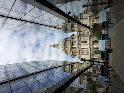 dome building in between glass walled building during daytime thumbnail