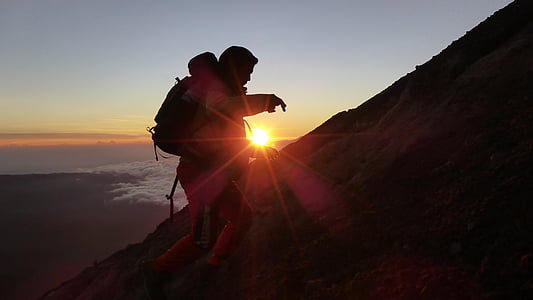 silhouette of person carrying backpack thumbnail