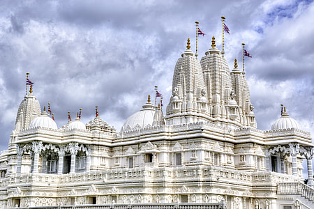 white concrete mosque under white cloudy sky thumbnail