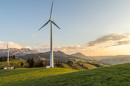 white windmill on green field during golden hour thumbnail