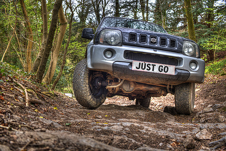 black Suzuki vehicle on forest thumbnail