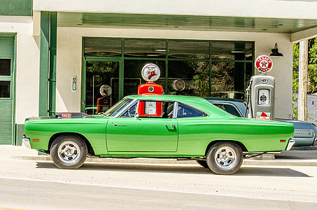 green muscle car parked on gasoline station thumbnail